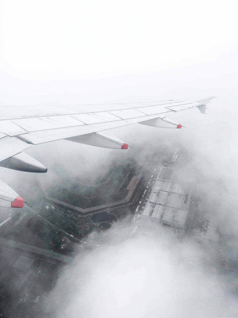 AERIAL VIEW OF AIRPLANE FLYING IN SKY DURING RAINY SEASON