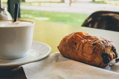 Close-up of coffee and snack on table