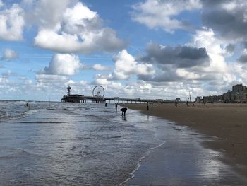 Panoramic view of beach against cloudy sky