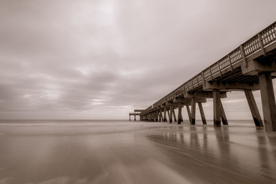 Pier over sea against sky