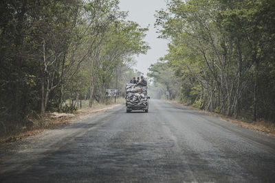 People traveling in vehicle on road