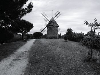 View of windmill against cloudy sky