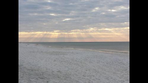 Scenic view of beach against sky during sunset