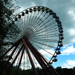 Low angle view of ferris wheel against sky