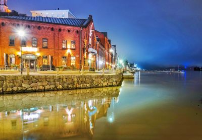 Reflection of illuminated buildings in water at night