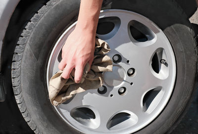 Close-up of human hand holding car