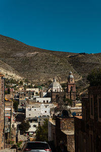 High angle view of townscape against clear blue sky