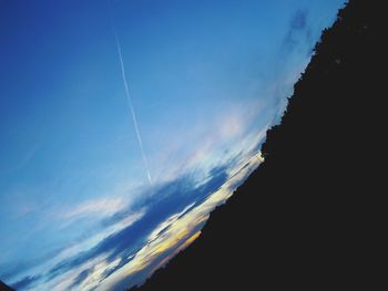 Low angle view of vapor trail in blue sky