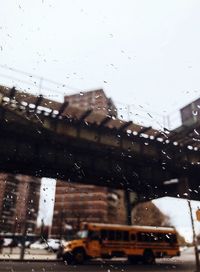 City seen through wet glass window during rainy season