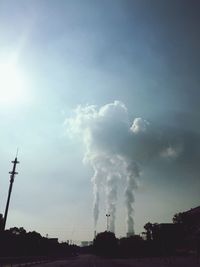 Low angle view of power lines against cloudy sky