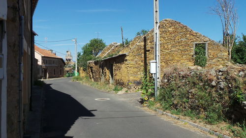 Empty road along buildings