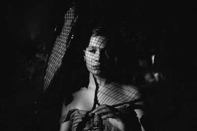 Close-up of girl with shadow in dark room