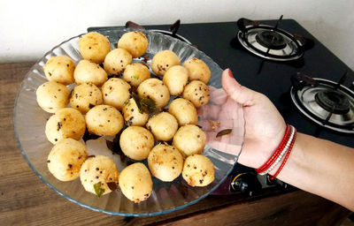 High angle view of person holding food on table