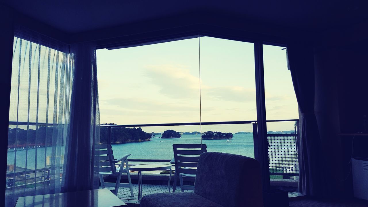 sky, window, day, indoors, curtain, sea, no people, horizon over water, chair, water, nature