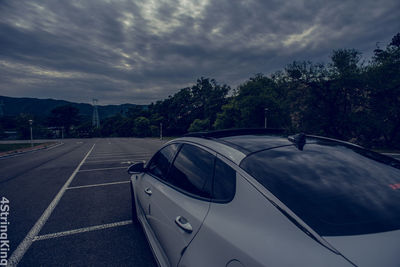 Car on road against sky in city