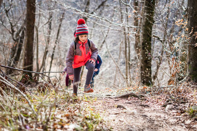 Full length of a boy standing on snow covered land