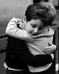 Boy embracing brother