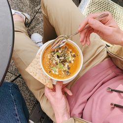 Low section of woman holding food