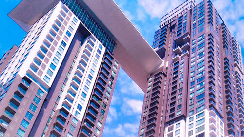 Low angle view of modern buildings in city against sky