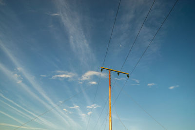 Low angle view of electric pole against sky