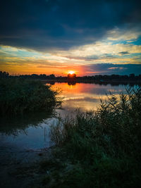 Scenic view of lake against sky during sunset