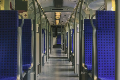 Empty corridor in illuminated building