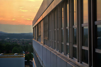 Buildings in city at sunset