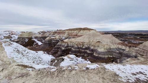 Rocks on landscape against sky