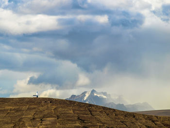 Scenic view of landscape against cloudy sky