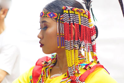 Close-up portrait of a young woman looking away