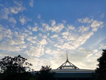 Low angle view of silhouette trees against sky