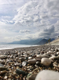 Stones on beach against sky