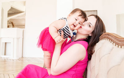 Happy mother and daughter at home