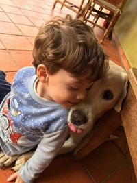 Cute boy sitting with dog