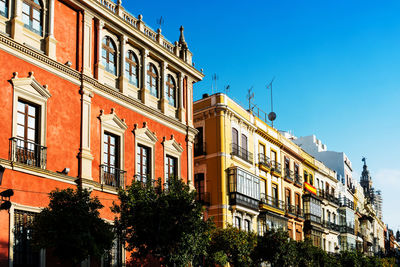 Low angle view of buildings against blue sky