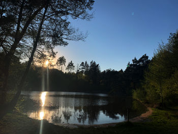 Scenic view of lake against sky at sunset