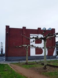 Text on old building against clear sky