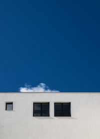 Low angle view of built structure against blue sky