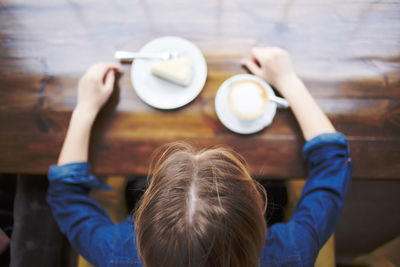 Rear view of woman holding drink