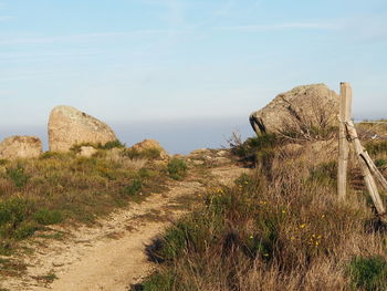 View of rocks on land against sky