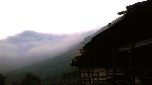 Scenic view of mountains against cloudy sky