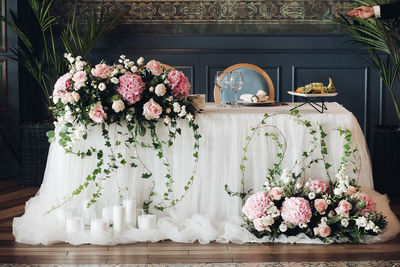 Roses in vase against wall