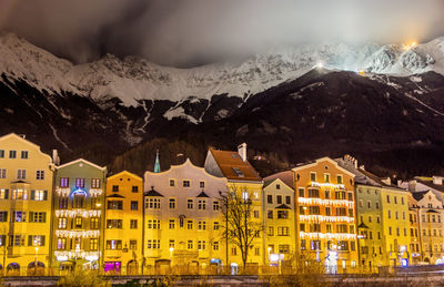 Buildings against mountains during winter