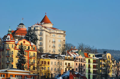 Buildings in city against clear sky