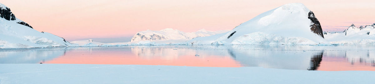 Scenic view of frozen lake against sky during winter