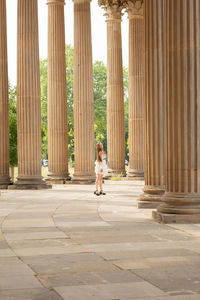 Man sitting on colonnade