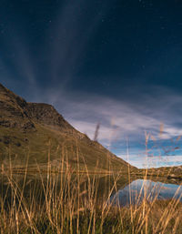 Scenic view of mountains against sky at night