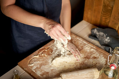 Midsection of woman preparing food at home