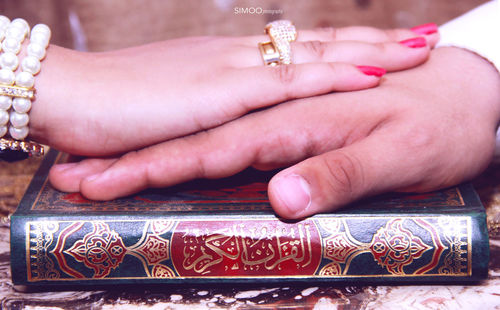 Close-up of hands holding cross