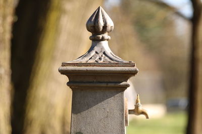 Close-up of faucet on concrete sculpture at park